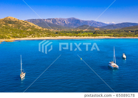 Sailboats moored in natural bay 65089178