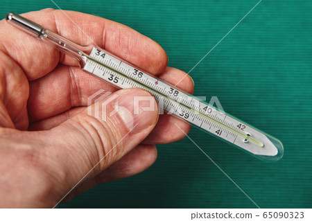 Mercury thermometer shows a high body temperature. Mercury thermometer shows a high body temperature. 65090323