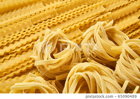 background of dried pasta, tagliatelle and background of dried pasta, tagliatelle and 65090489