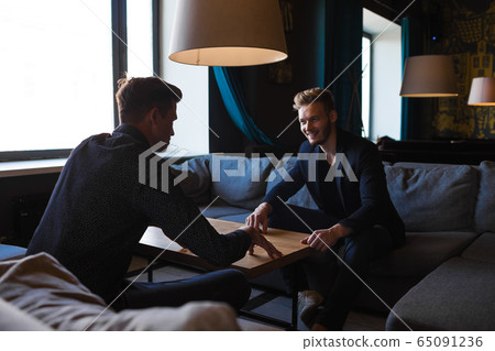 Businessmen congratulated themselves on their foresight in keeping out of it in cafe Businessmen congratulated themselves on their foresight in keeping out of it in cafe 65091236