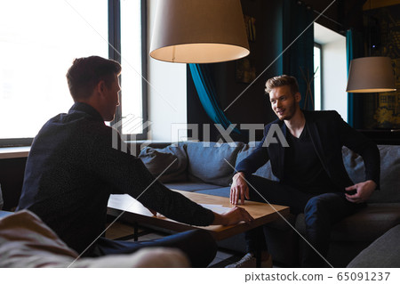 Businessmen congratulated themselves on their foresight in keeping out of it in cafe Businessmen congratulated themselves on their foresight in keeping out of it in cafe 65091237