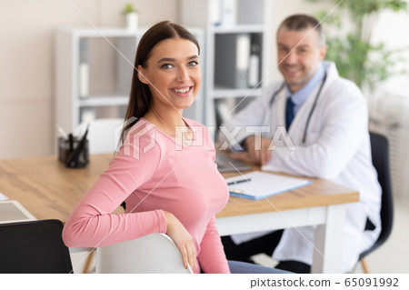 Patient receiving medical consultation and looking at camera Patient receiving medical consultation and looking at camera 65091992
