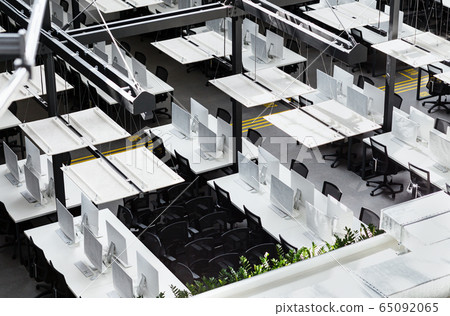 Co-working space with modern computers hiding by covers 65092065