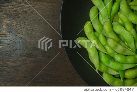 The Edamame in black plate top view image for food content. The Edamame in black plate top view image for food content. 65094847