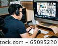 Young business man using computer for a online meeting with his colleagues in video conference.  65095220