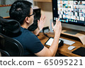 Young business man using computer for a online meeting with his colleagues in video conference.  65095221