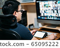 Young business man using computer for a online meeting with his colleagues in video conference.  65095222