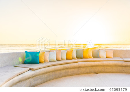 Comfortable pillow on sofa chair around outdoor patio with sea ocean beach view Comfortable pillow on sofa chair around outdoor patio with sea ocean beach view 65095579