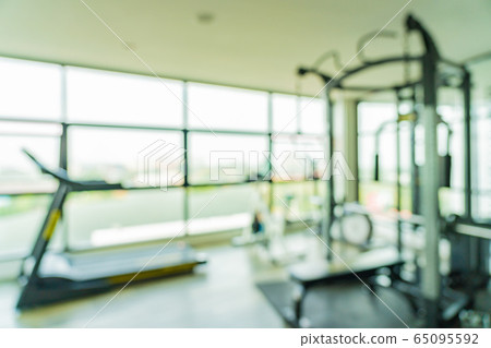 Abstract blur fitness equipment in gym room interior 65095592
