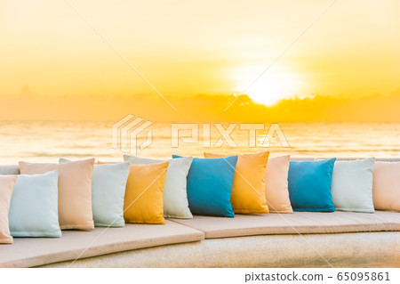 Comfortable pillow on sofa chair around outdoor patio with sea ocean beach view Comfortable pillow on sofa chair around outdoor patio with sea ocean beach view 65095861