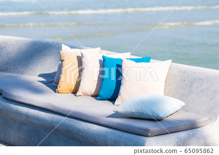Pillow on chair or sofa lounge around outdoor patio with sea ocean beach view Pillow on chair or sofa lounge around outdoor patio with sea ocean beach view 65095862