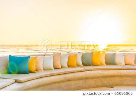 Comfortable pillow on sofa chair around outdoor patio with sea ocean beach view Comfortable pillow on sofa chair around outdoor patio with sea ocean beach view 65095863