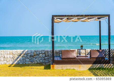 Pillow on sofa bed with lounge around beach ocean sea and blue sky Pillow on sofa bed with lounge around beach ocean sea and blue sky 65095869