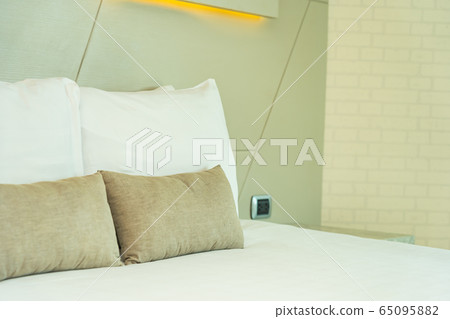 White comfortable pillow on bed decoration interior White comfortable pillow on bed decoration interior 65095882
