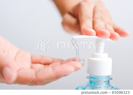 Close up woman applying press dispenser sanitizer Close up woman applying press dispenser sanitizer 65096323