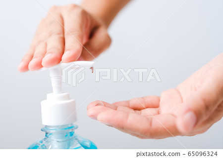 Close up woman applying press dispenser sanitizer Close up woman applying press dispenser sanitizer 65096324