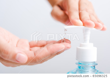 Close up woman applying press dispenser sanitizer Close up woman applying press dispenser sanitizer 65096325