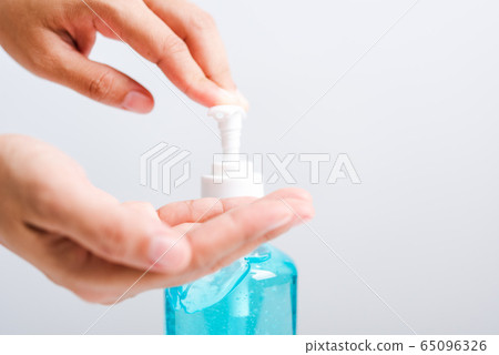Close up woman applying press dispenser sanitizer Close up woman applying press dispenser sanitizer 65096326