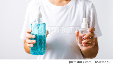 woman holding show dispenser sanitizer alcohol gel 65096330