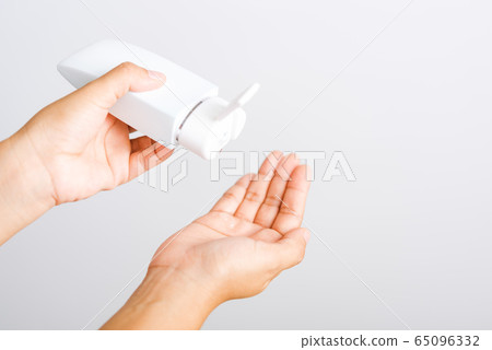 young woman applying drop dispenser sanitizer young woman applying drop dispenser sanitizer 65096332