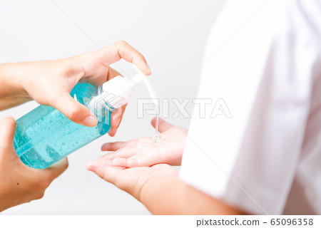 Mother applying pump dispenser alcohol gel 65096358