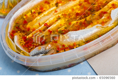 Herring preserves in a plastic jar 65096560