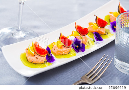 Tasty seafood ceviche from salmon with figs, kiwi and cumquat at plate Tasty seafood ceviche from salmon with figs, kiwi and cumquat at plate 65096639