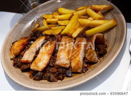 Iberian pork in sweet wine with stewed vegetables. Spanish dish Iberian pork in sweet wine with stewed vegetables. Spanish dish 65096647