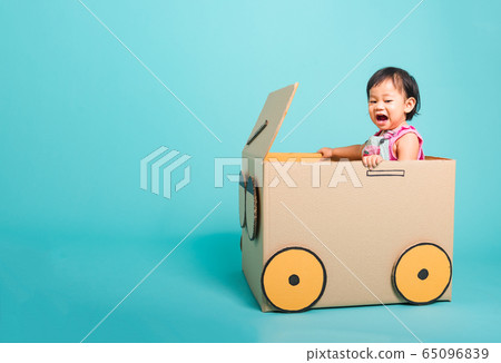 Baby girl smile in driving play car creative by a Baby girl smile in driving play car creative by a 65096839
