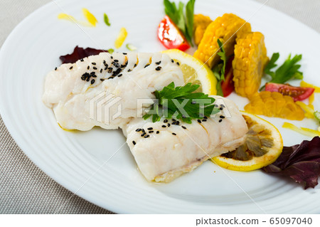 Codfish steamed and served with boiled corn, herbs and lemon Codfish steamed and served with boiled corn, herbs and lemon 65097040