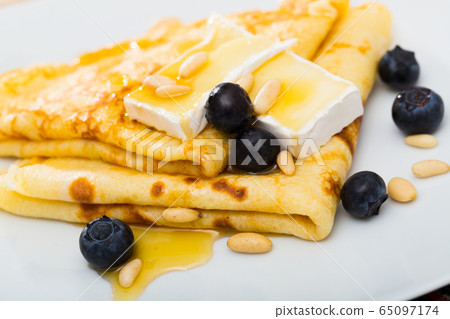 Thin pancakes with brie and honey Thin pancakes with brie and honey 65097174
