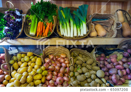 Market counter with large assortment of fresh vegetables for sale Market counter with large assortment of fresh vegetables for sale 65097208