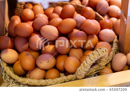 Farm fresh eggs in basket closeup Farm fresh eggs in basket closeup 65097209