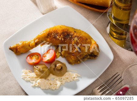 Grilled chicken leg quarter with baked onions and sauce Grilled chicken leg quarter with baked onions and sauce 65097285