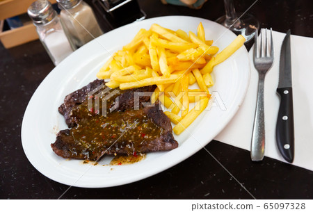 Veal steak in chimichurri sauce Veal steak in chimichurri sauce 65097328