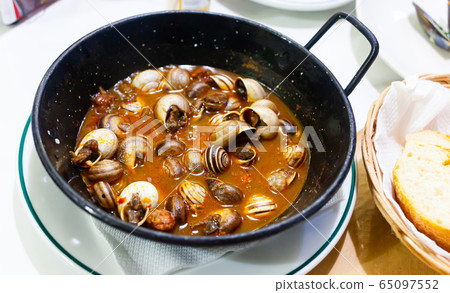 Picture of tasty baked in sauce snails in pan Picture of tasty baked in sauce snails in pan 65097552