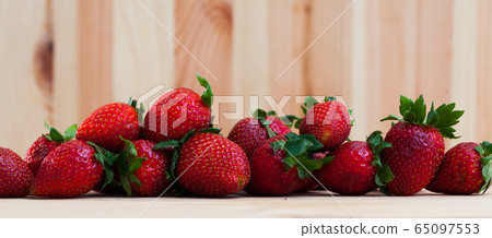 Ripe strawberries on a wooden table Ripe strawberries on a wooden table 65097553