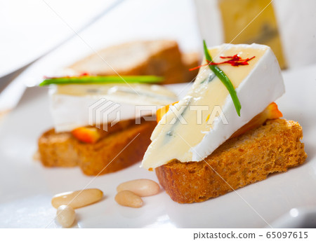 Canapes with soft blue cheese and orange Canapes with soft blue cheese and orange 65097615