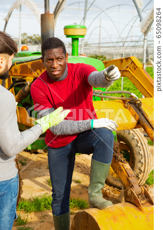 Quarrel of two farmers in greenhouse Quarrel of two farmers in greenhouse 65098264