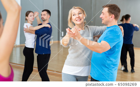 Middle aged woman practicing bachata 65098269