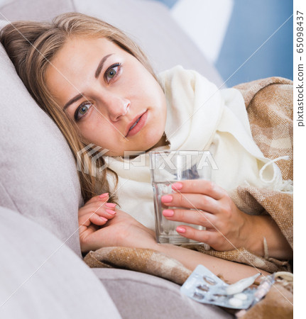 Sick girl on sofa taking drugs Sick girl on sofa taking drugs 65098437