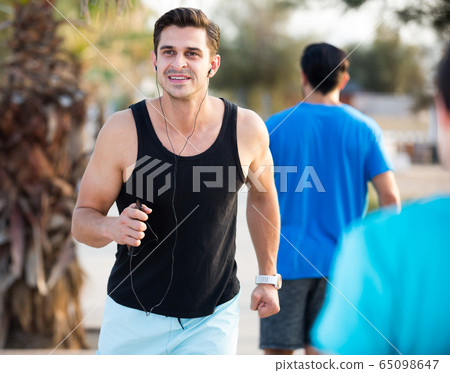 Portrait of adult man who is jogging with friend Portrait of adult man who is jogging with friend 65098647