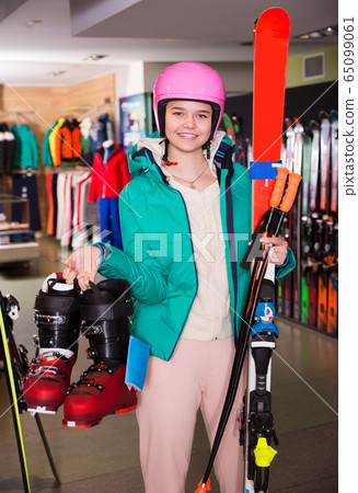 Nice girl in skiing outfit satisfied with choice Nice girl in skiing outfit satisfied with choice 65099061