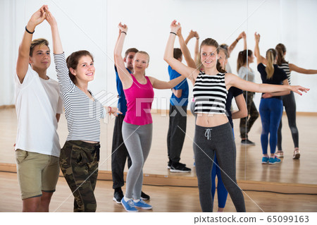 Happy teenagers dancing at dance school Happy teenagers dancing at dance school 65099163