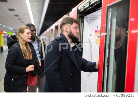 Young man landing in subway car 65099235