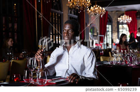 African-American man with glass of wine African-American man with glass of wine 65099239