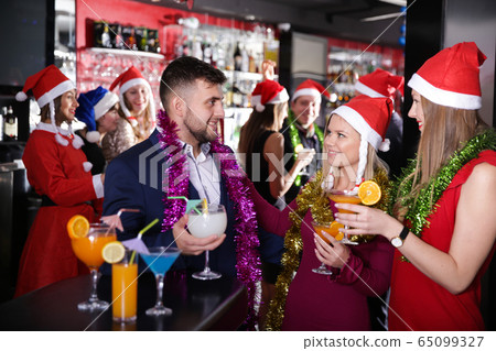 Guy with two girls on new year party in bar Guy with two girls on new year party in bar 65099327