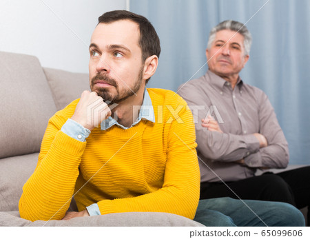 Adult father and son solve problems Adult father and son solve problems 65099606