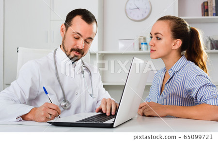 Woman having consultation with male doctor in hospital Woman having consultation with male doctor in hospital 65099721