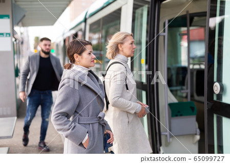 People boarding streetcar 65099727